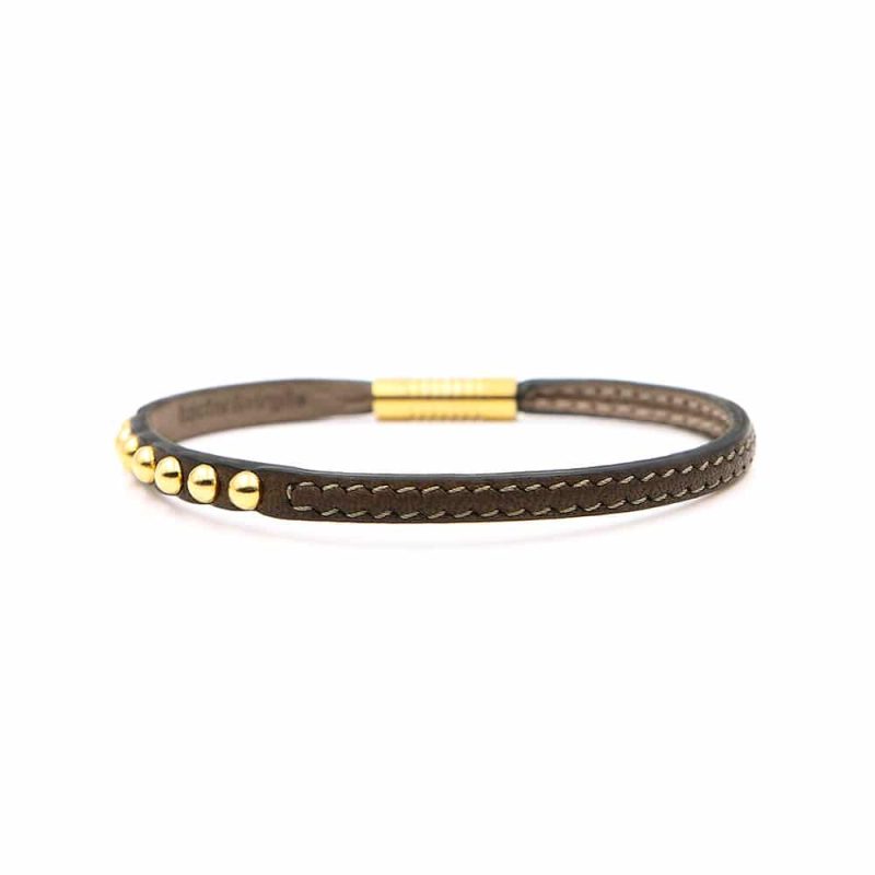 Bracelet en cuir artisanal pour femme Sirli avec un design à la fois classique et original. Made in France, haut de gamme. Couleur marron foncé et boucle dorée. Fabriqué en France.